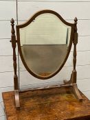 A shield dressing table mirror on turned supports