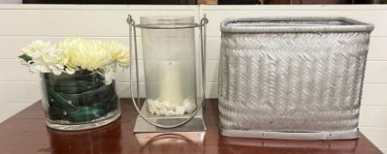 A glass and chrome hurricane lamp, a large glass vase and three nesting baskets
