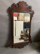 A Mahogany mirror with carved design