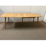 A light Ercol extending table (W150cm D80cm)