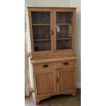 An antique pine dresser with double glazed doors on top of two drawers and cupboard under (H197cm