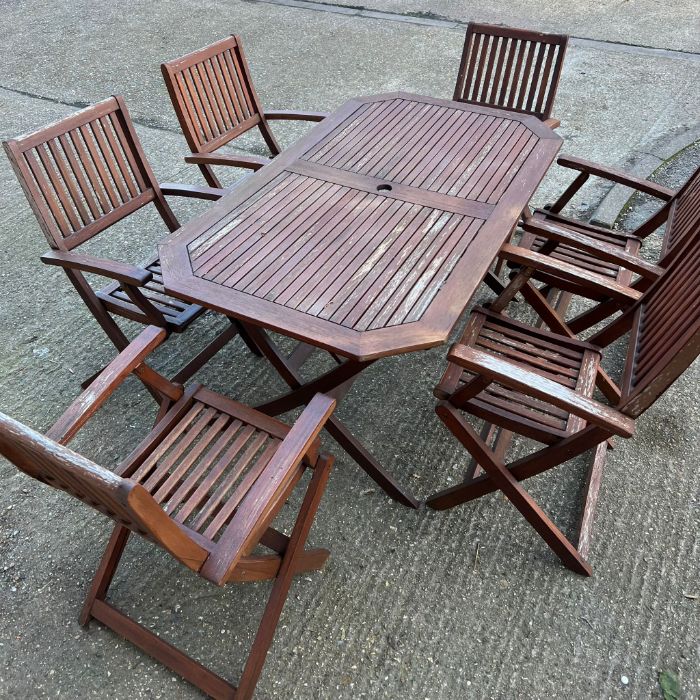 A six seater wooden garden table with folding chairs (H74cm W150cm D87cm) - Image 7 of 7