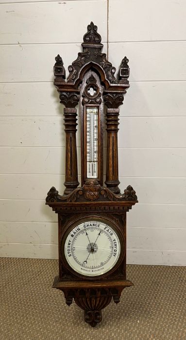 An oak cased barometer (H110cm W32cm)