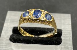 An 18ct gold three stone sapphire ring (Stones untested total weight 3.9g)