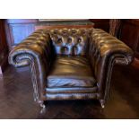 A leather Chesterfield club chair (H80cm W120cm D95cm)