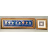 Two framed coin sets, an enamelled penny and the Sterling coin collection.