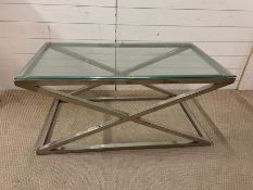 A glass and chrome cross frame coffee table (H50cm W110cm D60cm)