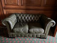 A small two seater Chesterfield sofa in green