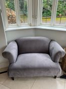 A contemporary two seater velvet sofa in grey (H68cm W130cm D86cm)