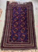 An antique purple rug 190cm x 113cm