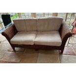 A two seater rattan sofa (H80cm W180cm D88cm)Condition Report no holes to rattan or repairs light