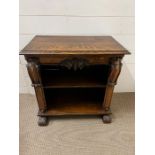 An oak side cabinet with scrolls to side and turned scroll legs (H61cm W60cm D33cm)