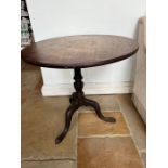 A circular occasional table on tripod down swept legs (H71cm Dia76cm)