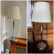 A pair of tall chrome lamps