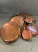 A collection of copper pans, etc.