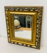 A gilt framed mirror