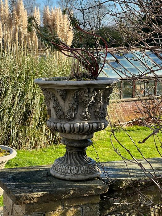 A pair of Bacchus relief garden urns