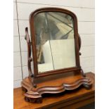 A mahogany toilet mirror or dressing mirror or dressing mirror on scrolling arm supports