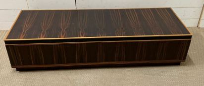 A low long rosewood style cabinet or media unit with soft touch closing and opening drawers under (