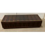 A low long rosewood style cabinet or media unit with soft touch closing and opening drawers under (