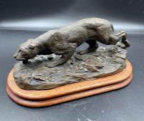 A Bronzed figure of a panther on plinth.