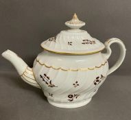 An 18th century fluted teapot.