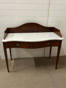 A serpentine front wash stand with marble top on tapering legs and string inlay (H100cm W116cm