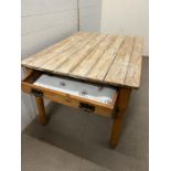 A distressed pine farmhouse kitchen table with drawer to end (H72cm W118cm D86cm)