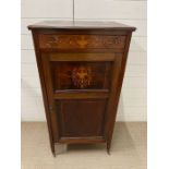 An Edwardian stained mahogany music cabinet with brass mount handles on castors