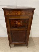 An Edwardian stained mahogany music cabinet with brass mount handles on castors