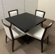 A contemporary dining table with ebony style table and four chairs