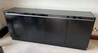 A black side cabinet with doors opening to shelves