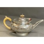 A Robert Harper silver teapot, engraved with the armorial Brackenbury, hallmarked for London 1879 (