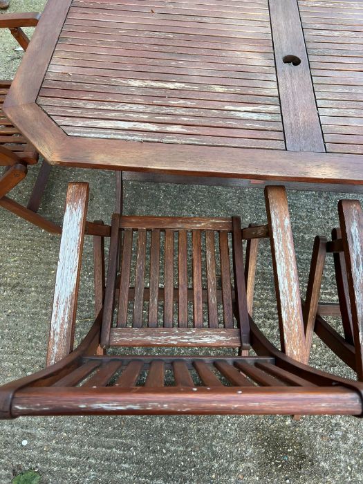 A six seater wooden garden table with folding chairs (H74cm W150cm D87cm) - Image 5 of 7