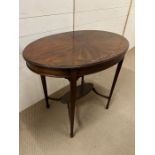 An oval centre table or occasional table on square tapered legs joined by an under tier