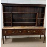 An oak dresser, the delft rack side shelves base with three drawers on straight legs, possibly