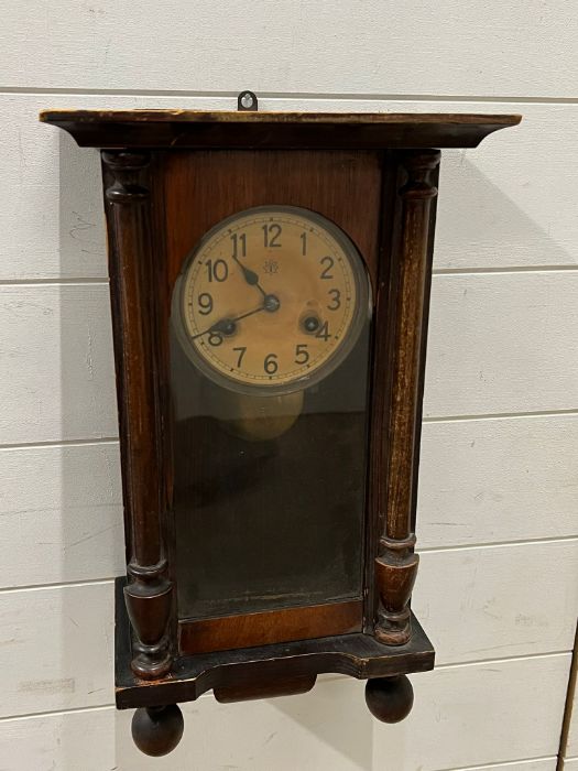 An oak cased wall clock