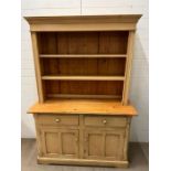 A Welsh dresser with open shelves to top and cupboards under (H81cm W132cm D49cm)