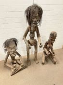 Three African or Indonesian tribal fertility figures