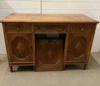 An oak desk with carved front and brass drop handles (H80cm W123cm D53cm)