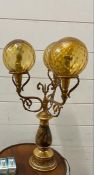 1960's lamp with three brass arms with glass sphere shades and painting hunting scene to base AF