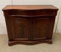 A mahogany side cabinet with serpentine front (H88cm W107cm D40cm)