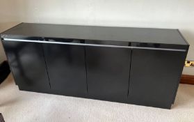 A black side cabinet with doors opening to shelves
