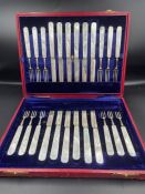 A cased silver and mother of pearl twelve place setting dessert cutlery set of knives and forks by