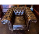 A leather Chesterfield club chair (H80cm W120cm D95cm)