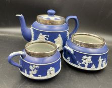 A Dark Blue Adams tea service with hallmarked silver rim.