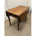 A drop sided mahogany table with faux drawer to one end and a working drawer to other