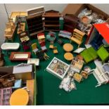 A large selection of dolls house furniture and accessories including dolls and some action man