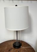 A Ralph Lauren table lamp with glass cylinder column on black base