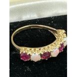 A 9ct yellow gold opal and garnet ring ( Total Weight 2.3g)